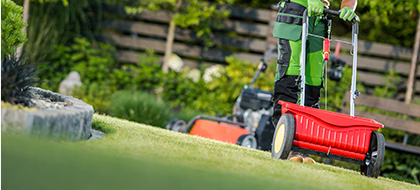 A lawnmower mowing a lawn
